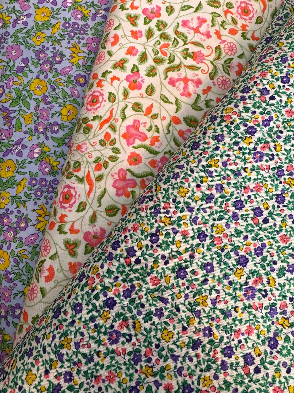 Three different floral fabric patterns arranged in a row.