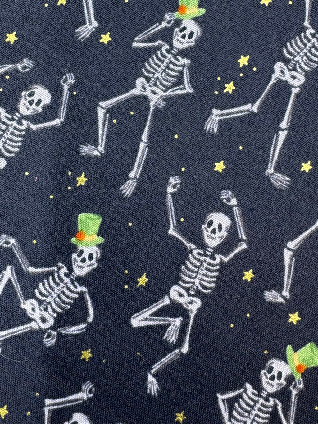 Fabric with skeleton pattern on a wooden surface