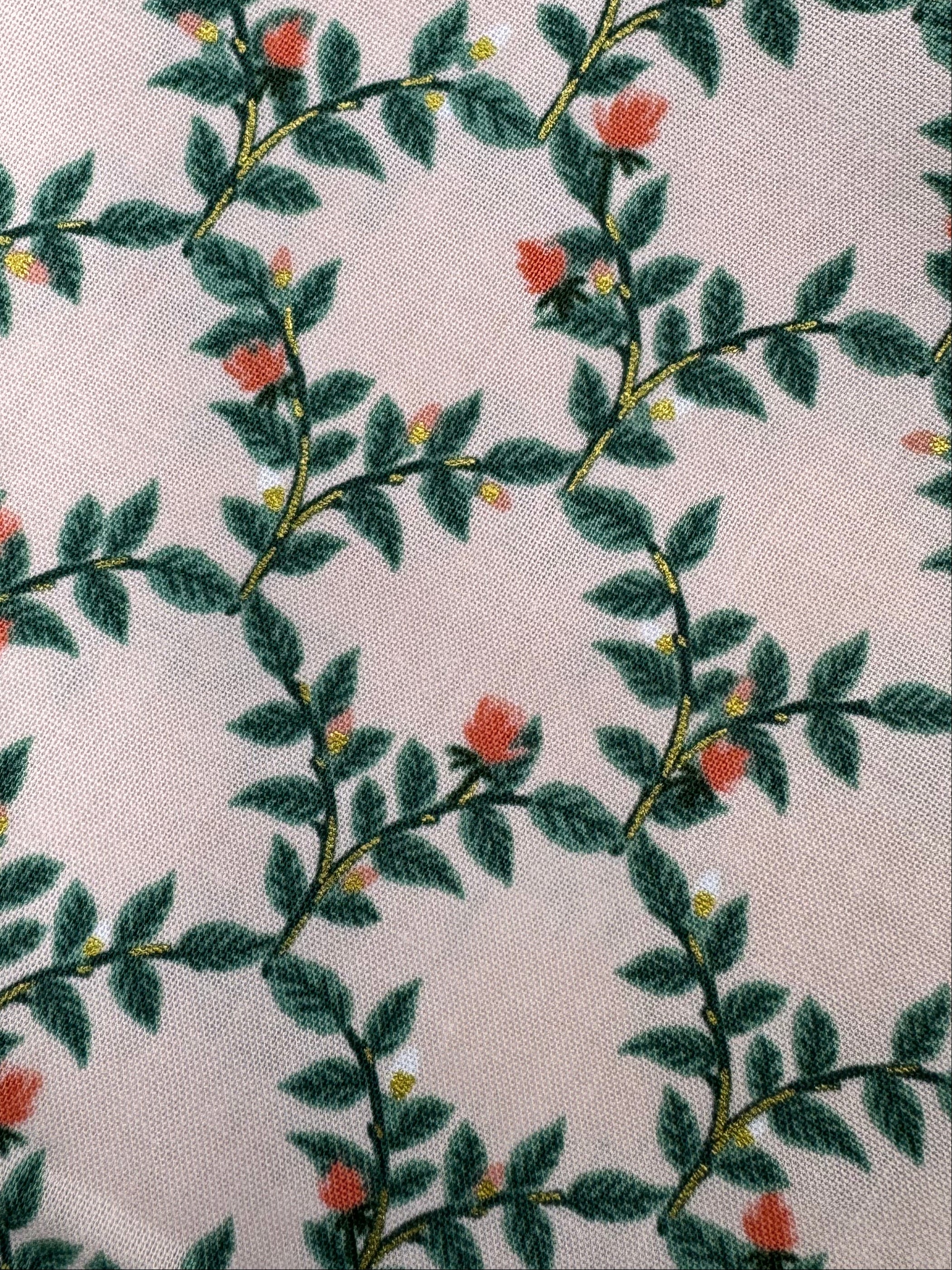 Fabric with leaf pattern on a wooden surface