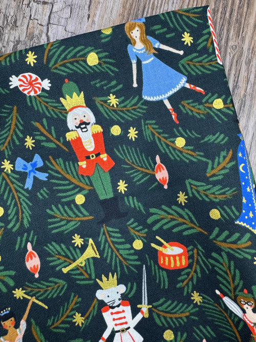 Festive fabric with Christmas-themed pattern on a wooden surface