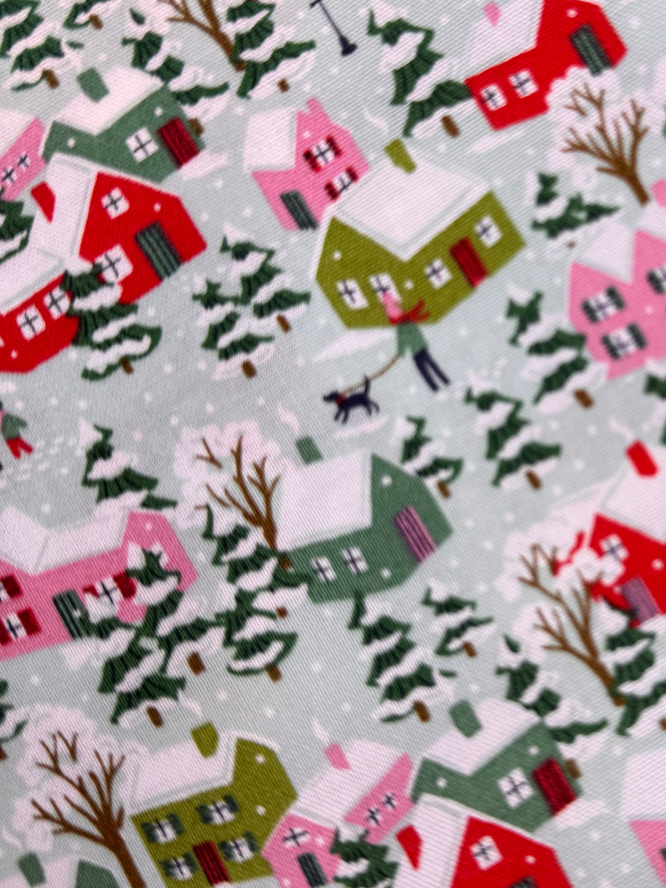 Fabric with a Christmas village pattern on a wooden surface