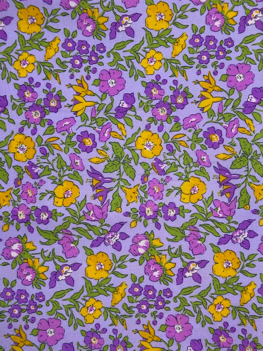 Floral pattern with purple and yellow flowers on a purple background