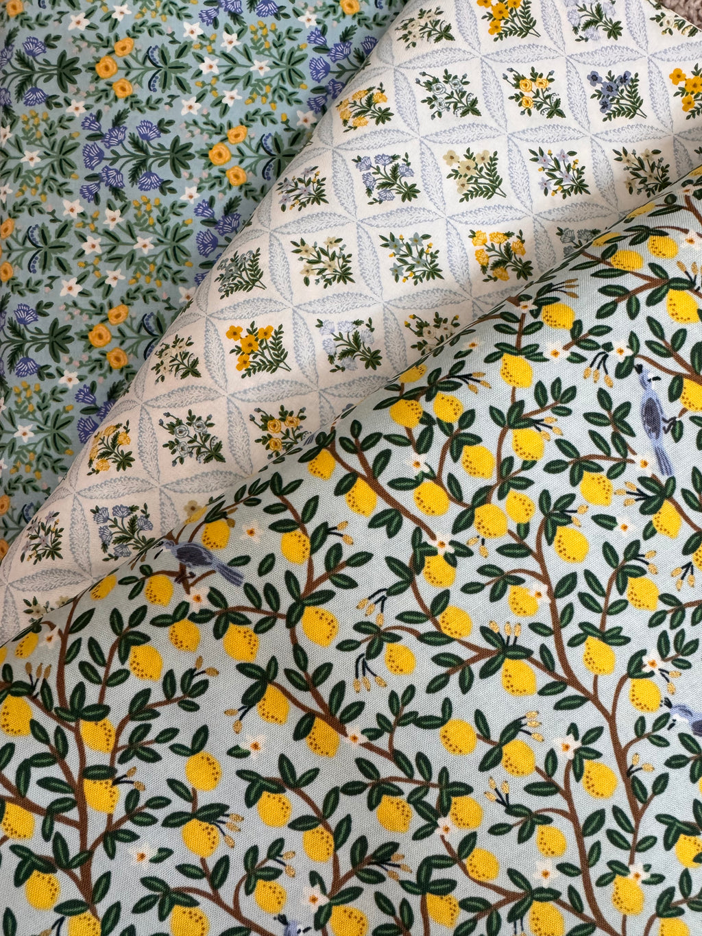 Three different floral patterns on fabric swatches.