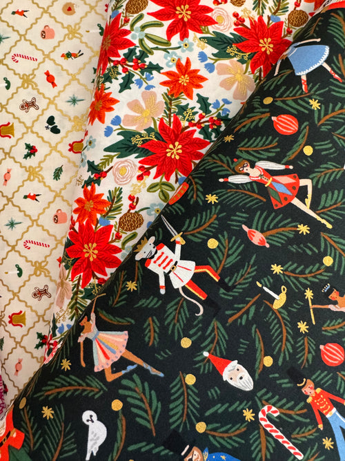 Three fabric swatches with festive patterns including poinsettias and holiday-themed designs.