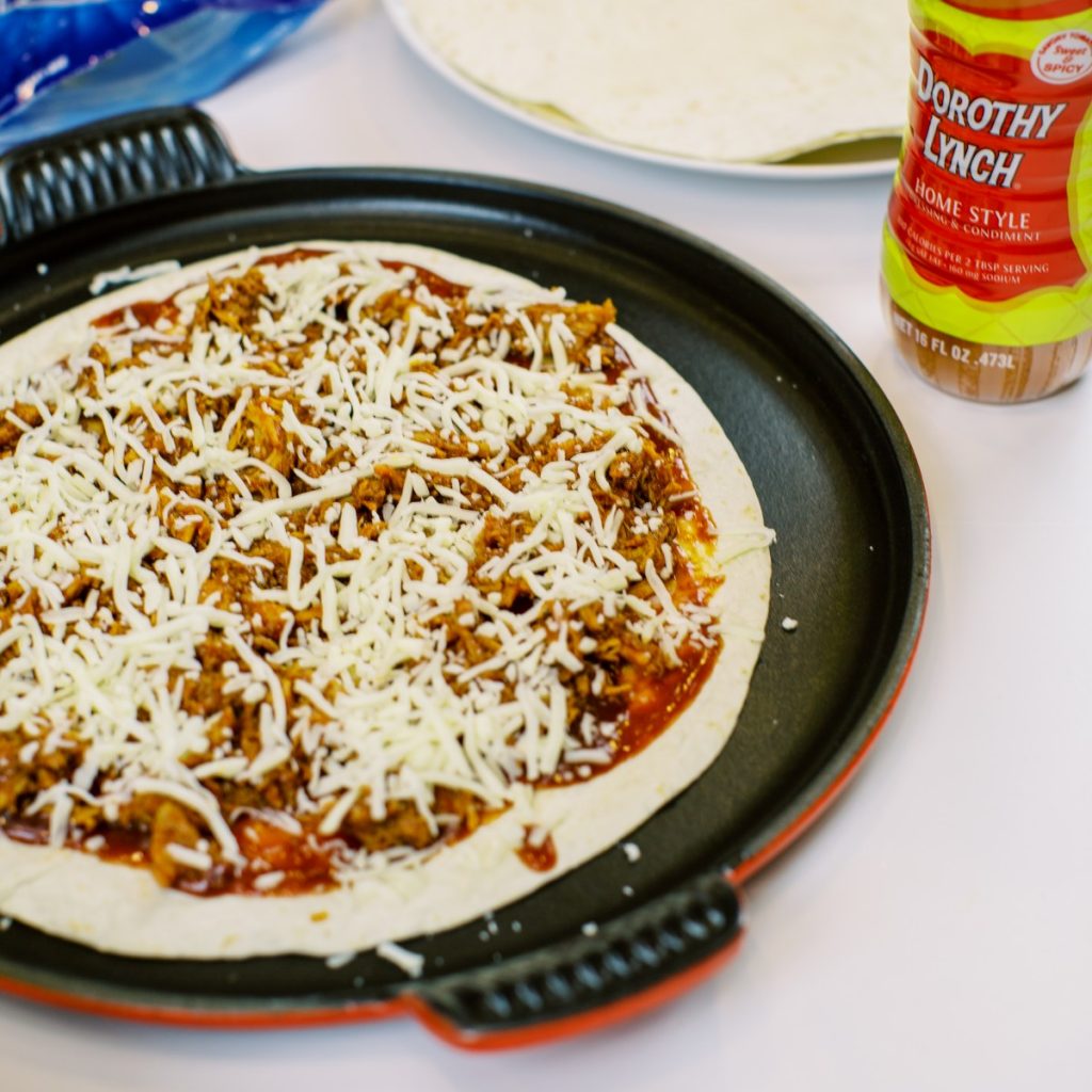 A BBQ Chicken Tortilla Pizza recipe that is perfect for summer entertaining. Made with Dorothy Lynch it's easy to make, quick to cook, and absolutely delicious.