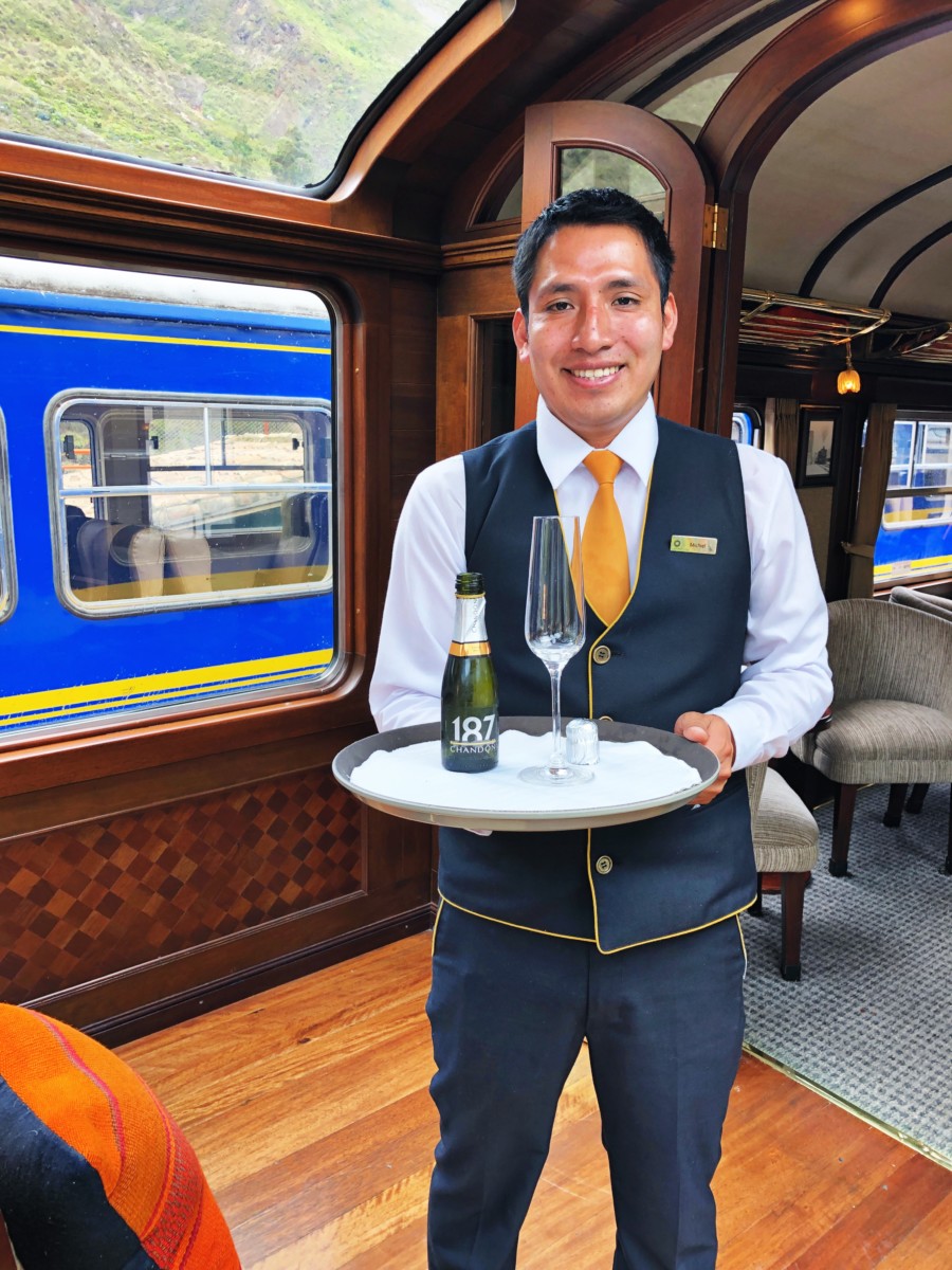 Man holding wine on Sacred Valley Train